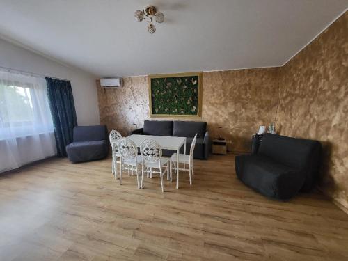 a living room with a table and chairs and a couch at Casa Ratiu 3 Stele Airport Bucharest Therme Bucharest in Baloteşti