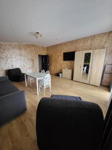 a living room with a couch and a table and chairs at Casa Ratiu 3 Stele Airport Bucharest Therme Bucharest in Baloteşti