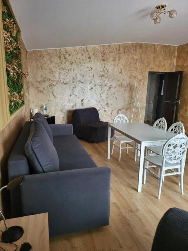 a living room with a couch and a table at Casa Ratiu 3 Stele Airport Bucharest Therme Bucharest in Baloteşti