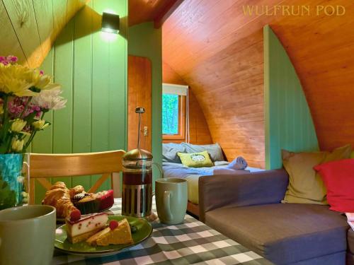 a room with a table with a plate of food at West Stow Pods in Bury St Edmunds in West Stow