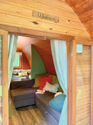 a room with a couch in a tiny house at West Stow Pods in Bury St Edmunds in West Stow