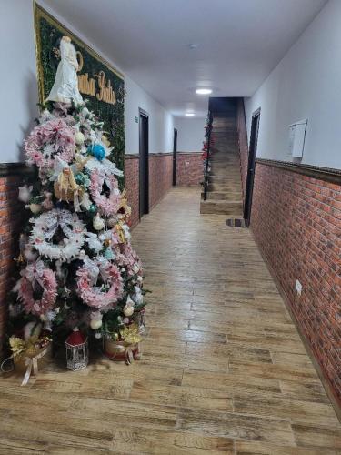 a christmas tree in the middle of a hallway at Casa Ratiu 3 Stele Airport Bucharest Therme Bucharest in Baloteşti