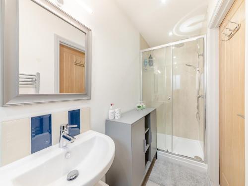 a white bathroom with a sink and a shower at Number 29 in Alnwick