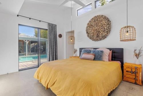 a bedroom with a large bed and a pool at Desert Flame - Couples Retreat near the Beach in Marcus Beach