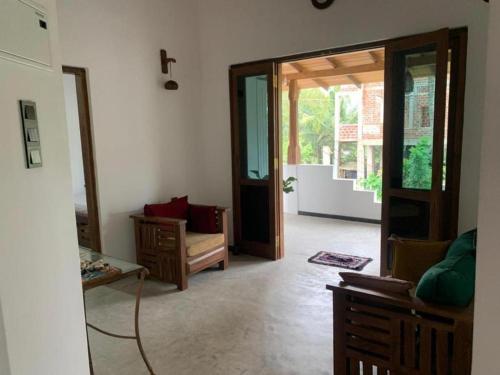 a living room with a cross on the wall at Sunil VIlla in Talpe