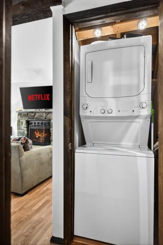 a white oven in a living room with a fireplace at Hideout Pocono Chalet in Lake Ariel
