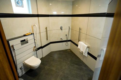 a bathroom with a toilet and a sink at PUTHUR RESIDENCY HOTELS PVT LTD in Trichūr