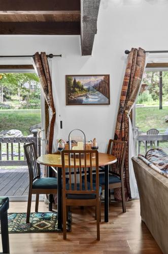 a dining room with a table and chairs on a porch at Hideout Pocono Chalet in Lake Ariel