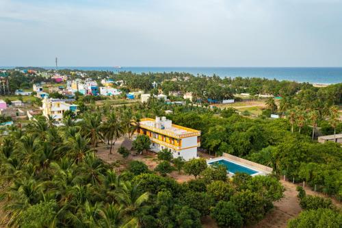 an aerial view of a resort and the ocean at Neithal Farm Resort with Swimming Pool by Roscotel in Puducherry