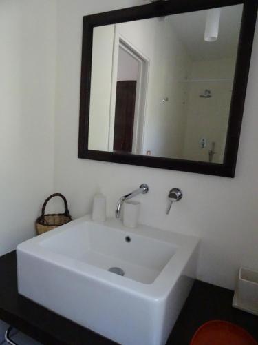 a white sink in a bathroom with a mirror at Villa dei Sogni in Vulcano