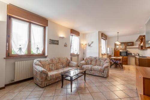 a living room with two couches and a table at La Casa di Nadia in Bussolengo