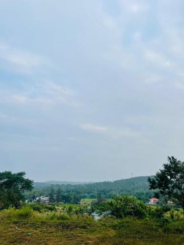a view of a city from a hill with trees at The Soul 1 Service Villa in Mananthavady