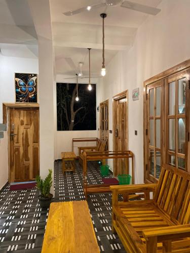 a row of wooden benches in a room at Eastern Bay in Arugam Bay