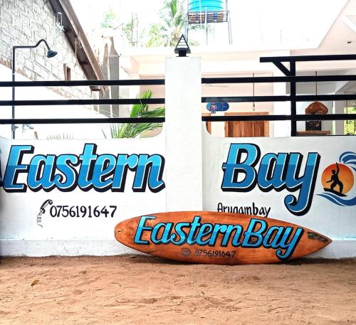 a surfboard sitting on the side of a building at Eastern Bay in Arugam Bay