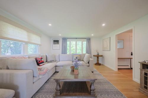 a living room with a couch and a coffee table at Tranquil Waterfront Getaway in Bourne