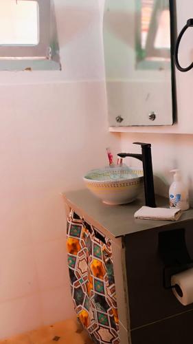 a bathroom with a sink and a bowl on a counter at Riad SULTANA lateral seaview in Saidia 
