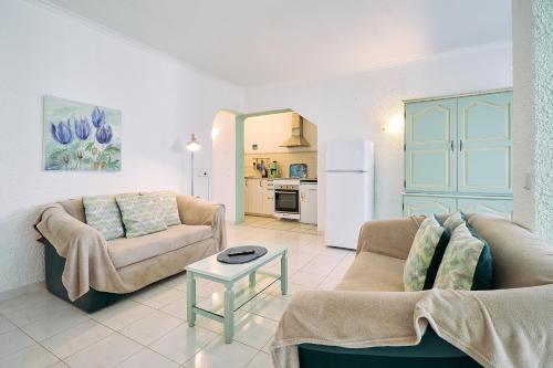 a living room with two couches and a table at Apartment Casa Cristiano in Carvoeiro