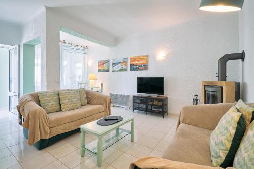 a living room with two couches and a tv at Apartment Casa Cristiano in Carvoeiro