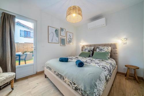 a bedroom with a bed and a large window at The Kings Haven with Garden in Bois-le-Roi