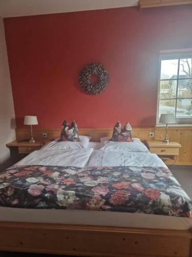 a bedroom with a bed with a quilt on it at Hildebrandts Landhotel in Klettbach