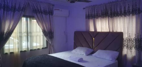 a bed with two white pillows in a bedroom at 3JD Lavishly Furnished 3-Bed Apartment in Lagos