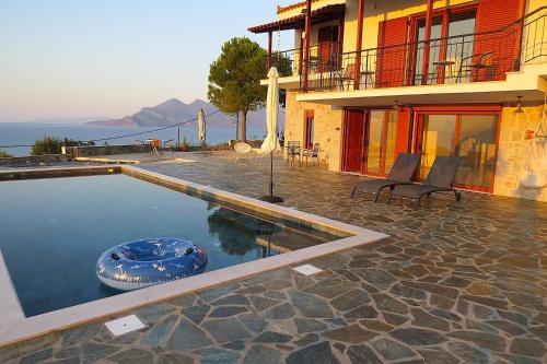a house with a swimming pool next to a building at NISIDA Resort & Meditation center - Adult only in Áno Fanárion