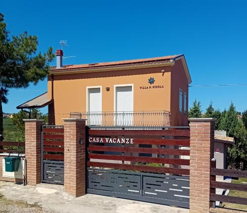 a house with a gate and a fence at Villa Nonno Nicola in Montenero di Bisaccia