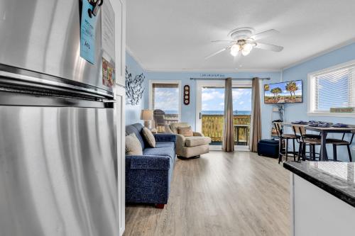 a kitchen and living room with a stainless steel refrigerator at Sea Cabin in Myrtle Beach