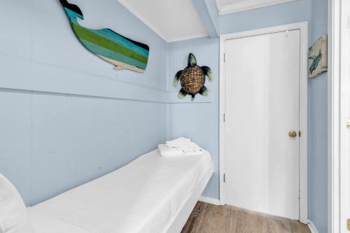 a room with a white couch and a turtle on the wall at Sea Cabin in Myrtle Beach