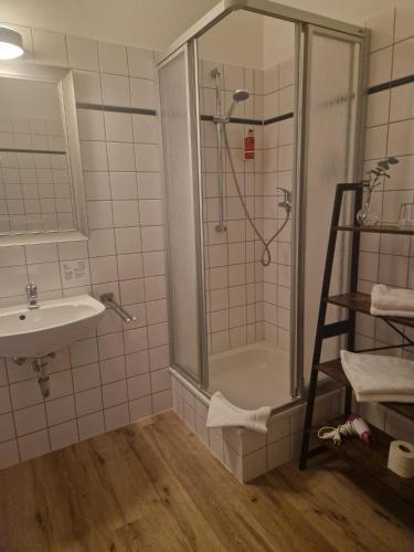 a bathroom with a shower and a sink at Hildebrandts Landhotel in Klettbach