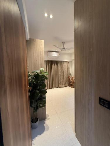 a room with a hallway with a potted plant at Airnest Stays- Bohemian in Mumbai