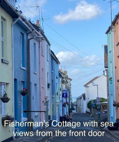 a city with the text fishmans cottage with sea views from the front door at Fisherman's Cottage - Harbour Close, Pub Closer, Sea Views if You Look Hard in Brixham