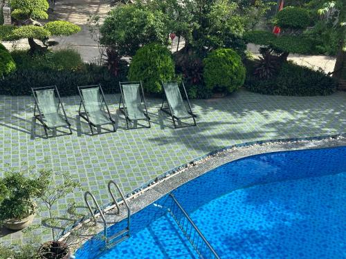 a row of chairs next to a swimming pool at Trang An ViewPoint Homestay in Ninh Binh