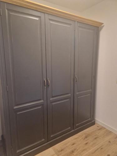 a set of three gray cabinets in a room at Hildebrandts Landhotel in Klettbach