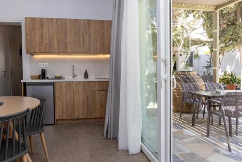 a kitchen and dining room with a table and chairs at Green Dream in Tinos Town
