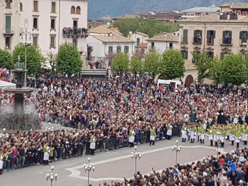 a large crowd of people watching a parade at Piazza Maggiore in Sulmona