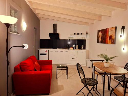 a living room with a red couch and a table at Alegria apartments in Gaios