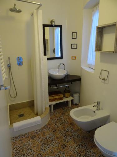 a bathroom with a sink and a toilet at Villa dei Sogni in Vulcano