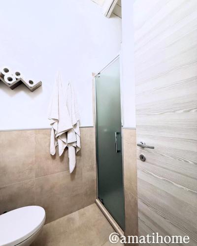 a bathroom with a shower and a toilet at Amati home in Floridia