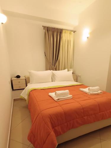 a bedroom with a bed with two towels on it at To Agioklima in Ioannina