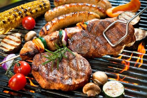 a bunch of meat and vegetables on a grill at Bellavista Porto Rotondo in Porto Rotondo