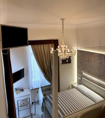 a bedroom with a bunk bed and a chandelier at Le Suite del Duomo in Cava deʼ Tirreni