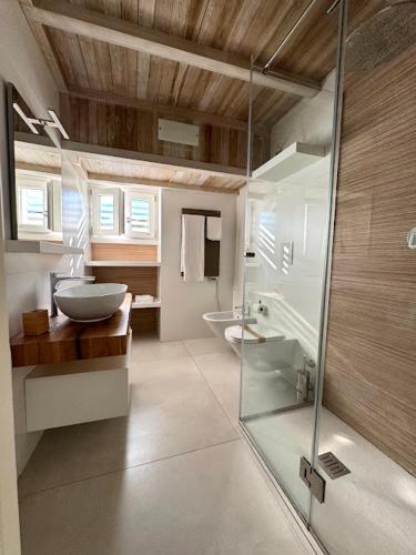 a bathroom with a glass shower and a sink at Le Suite del Duomo in Cava deʼ Tirreni
