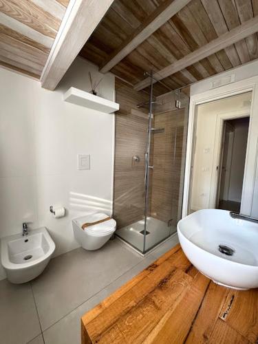 a bathroom with a sink and a tub and a toilet at Le Suite del Duomo in Cava deʼ Tirreni