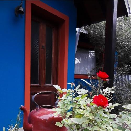 a red vase sitting in front of a house at Kiritina´s House Homestay in El Calafate
