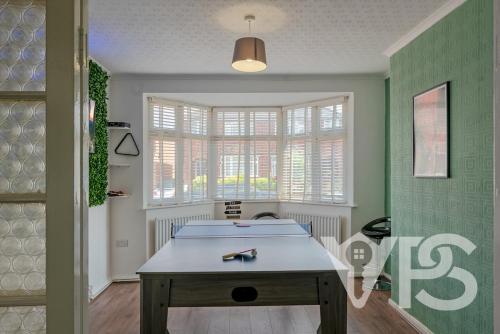 a room with a table and a window at Family&GroupRetreat GamesRoom in Leicester