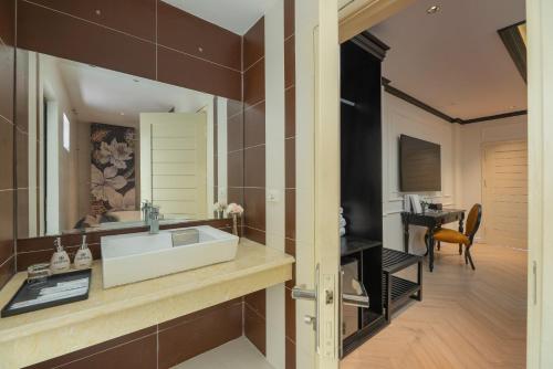 a bathroom with a sink and a mirror at Golden Boutique Hotel in Hanoi