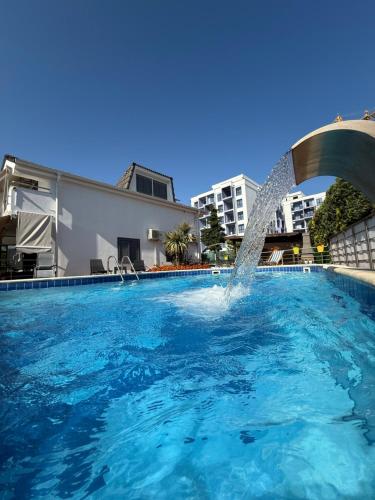 a swimming pool with a fountain in the middle at Villa 31 Oasis in Golem
