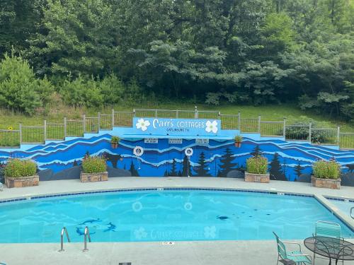 a swimming pool with a sign that says christmas surprises at Carr's Northside Hotel and Cottages in Gatlinburg