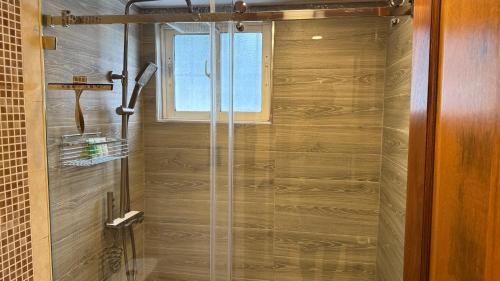 a shower with a glass door in a bathroom at Cozy and Beautiful, 3 Bedroom Apartment Home in Santo Domingo